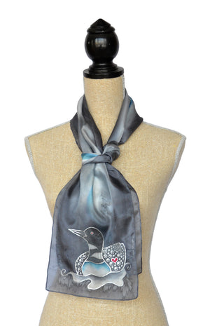 Hand-Painted silk scarf with Canadian loon design in medium grey on mannequin